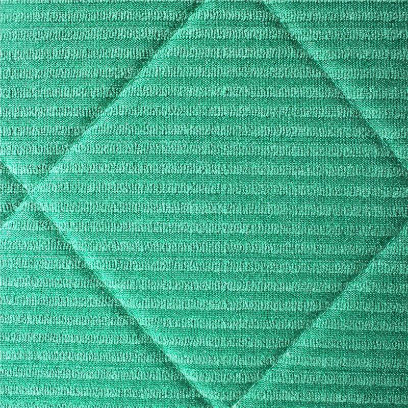 Green kitchen cleaning cloth made of polyester with subtle striped pattern and textured surface for pots and bowls