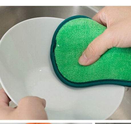 Kitchen cleaning towel in green microfiber fabric with teal edging used to clean a white bowl
