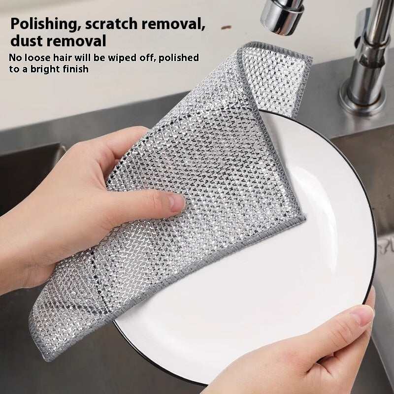 Metal Wire Cleaning Cloth in silver color with textured wire mesh pattern used for polishing and scratching removal on a white plate